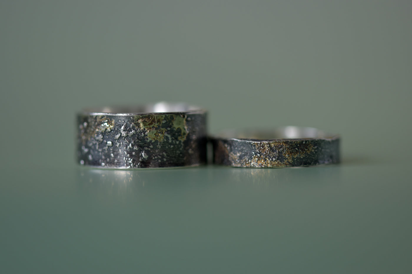 Molten 18ct Gold and Sterling Silver Rings Green Background