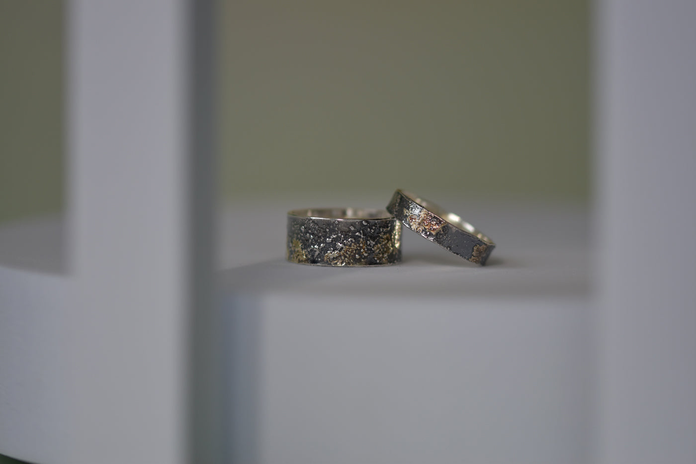 Molten 18ct Gold and Sterling Silver Rings on Display Stand