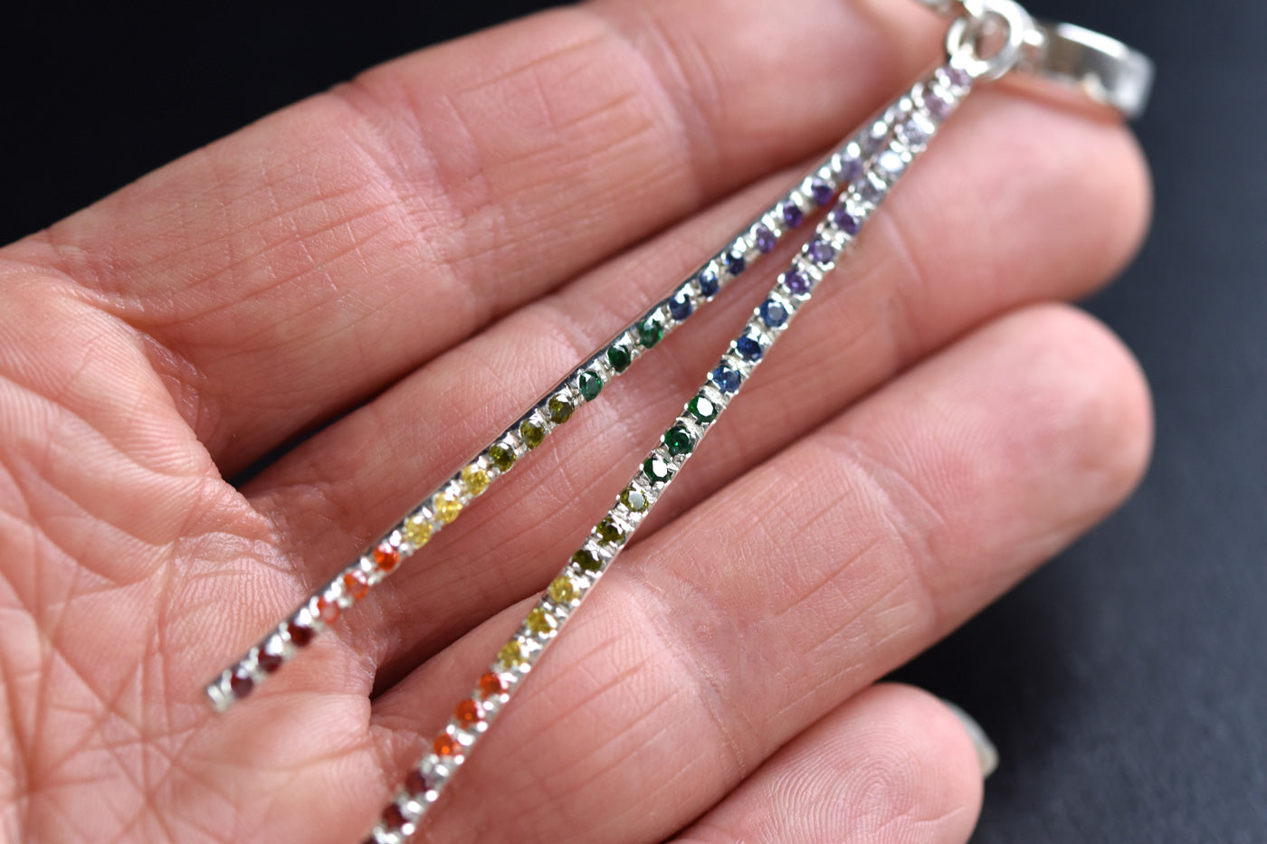 Sterling Silver Rainbow Bar Huggie Hoops in Hand