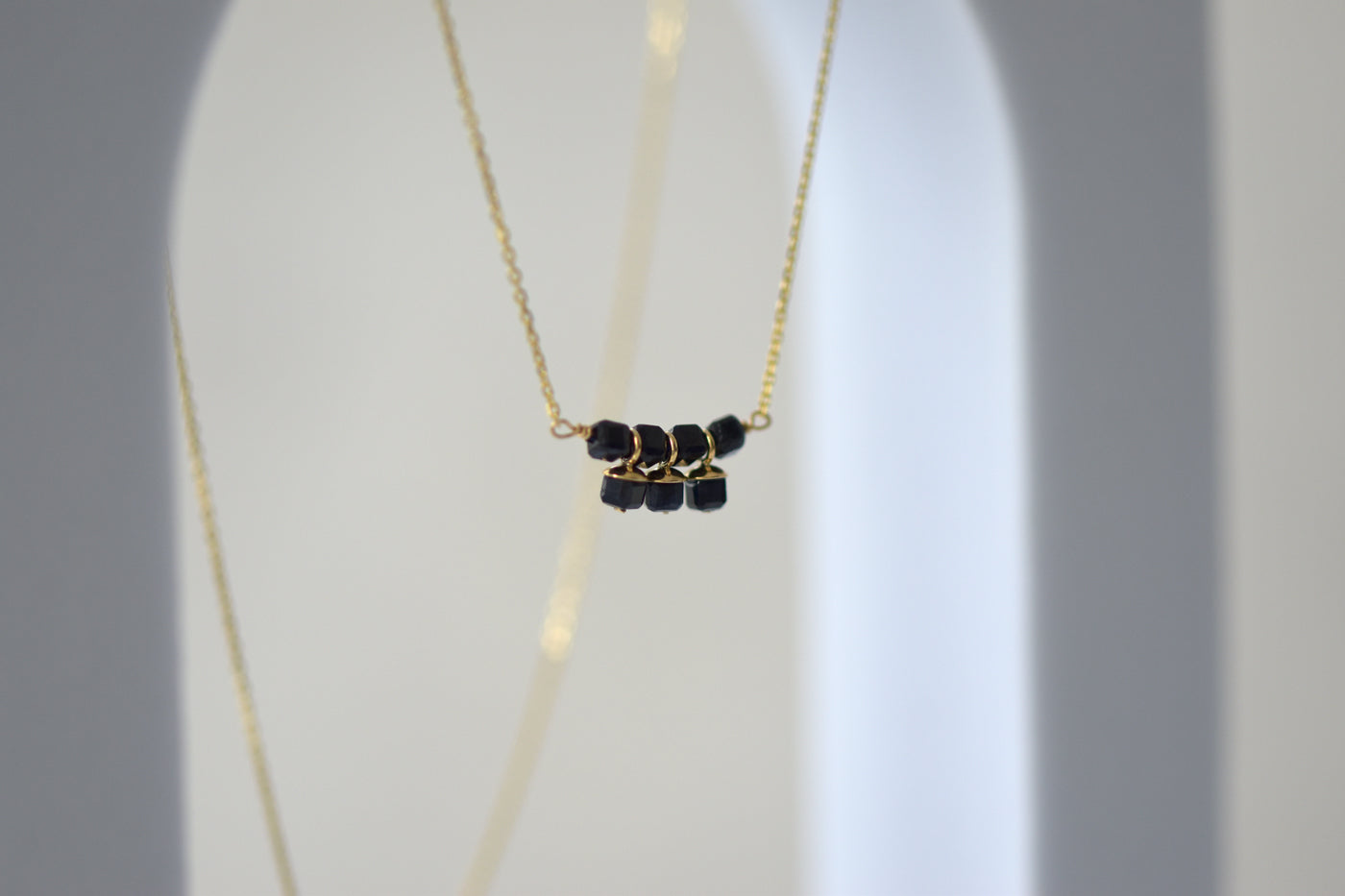 9ct Gold Sapphire Cube Necklace on Display