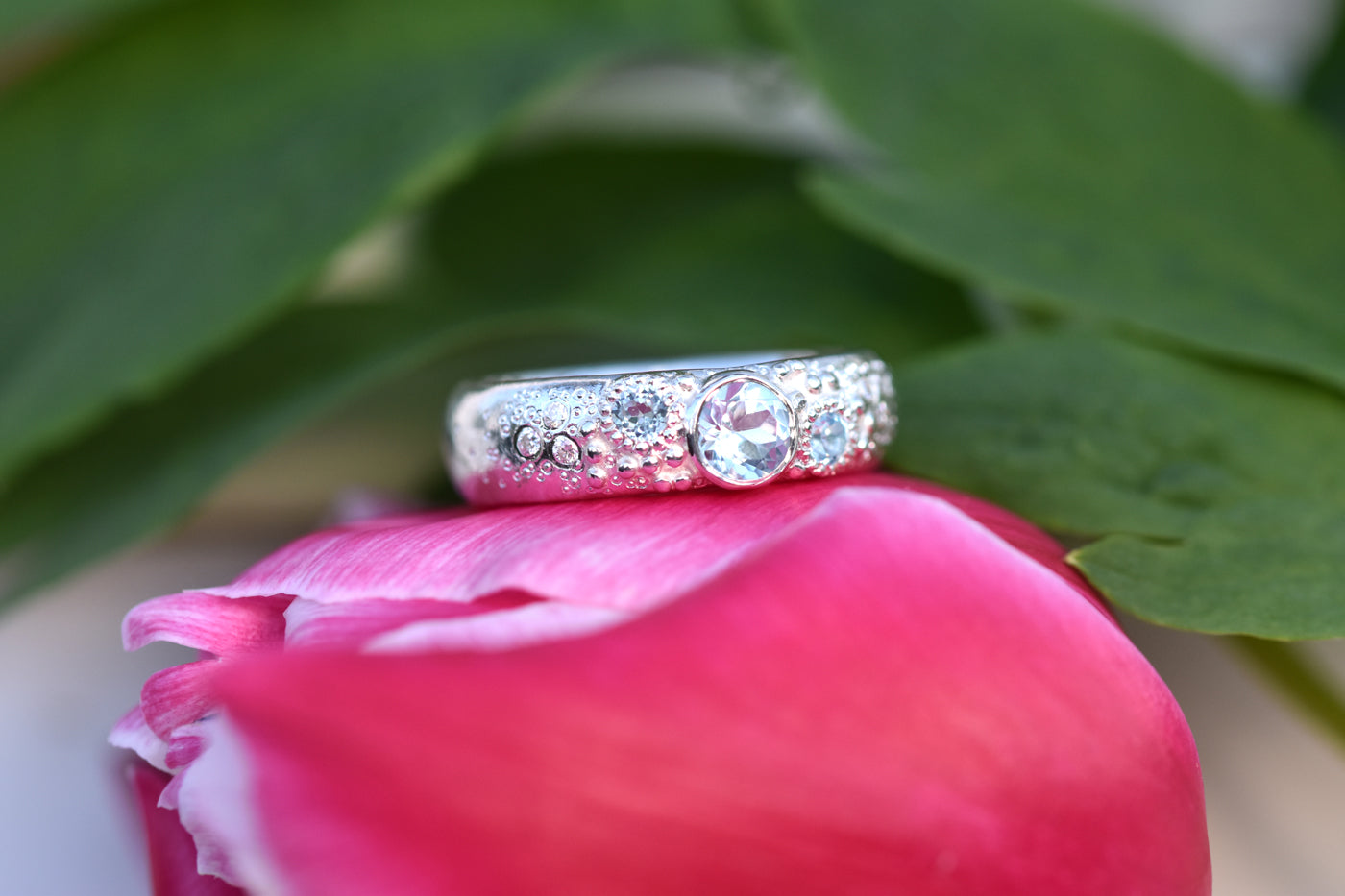 Blue Topaz Sirens Ring Displayed on Flower